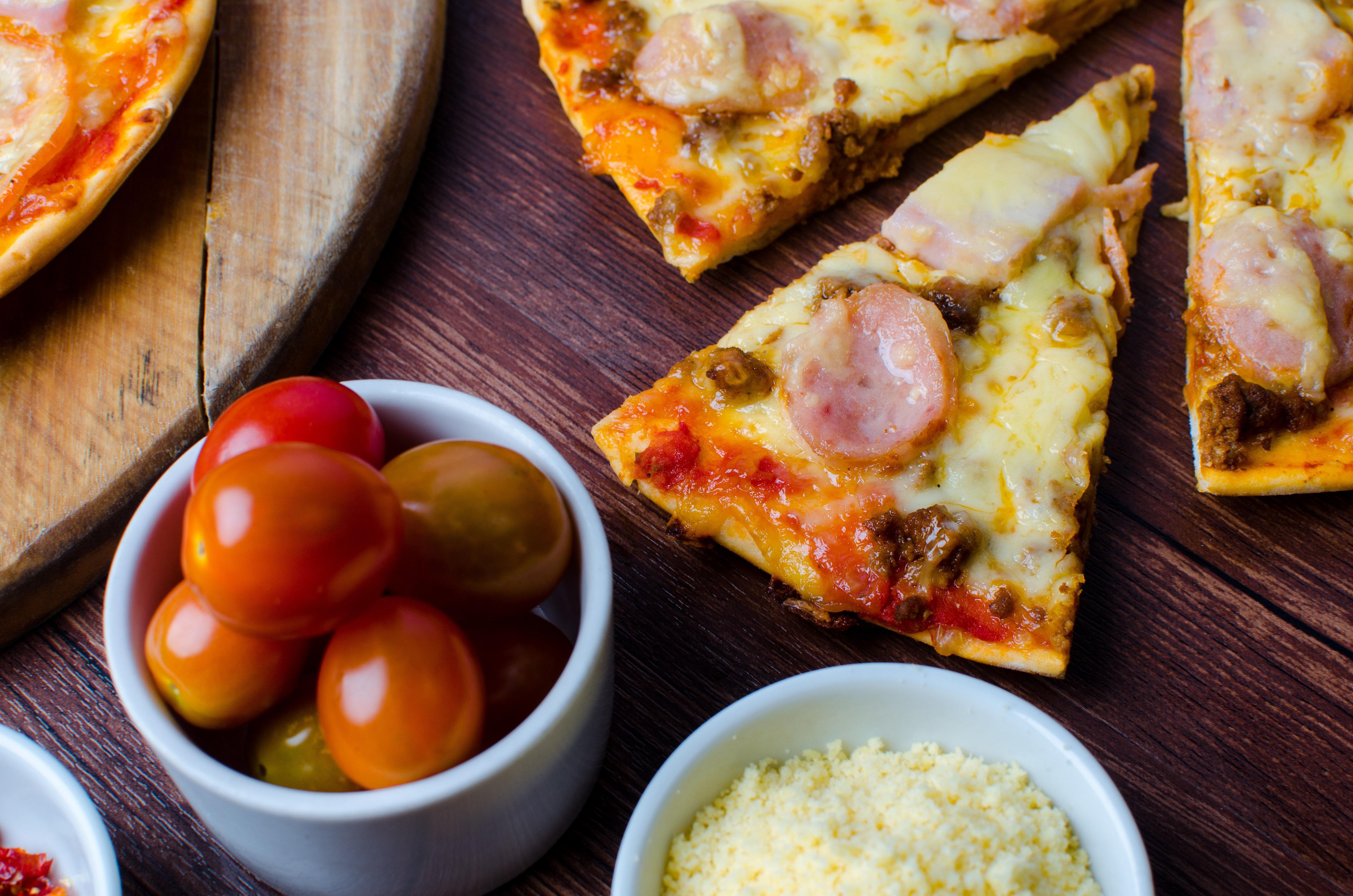 Holiday Inn & Suites Makati By Ihg Makati City Exterior photo A pizza with sausage and cheese